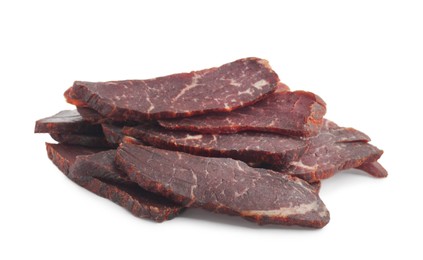 Pieces of delicious beef jerky on white background