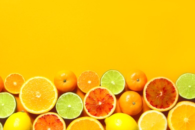 Different citrus fruits on color background, flat lay. Space for text