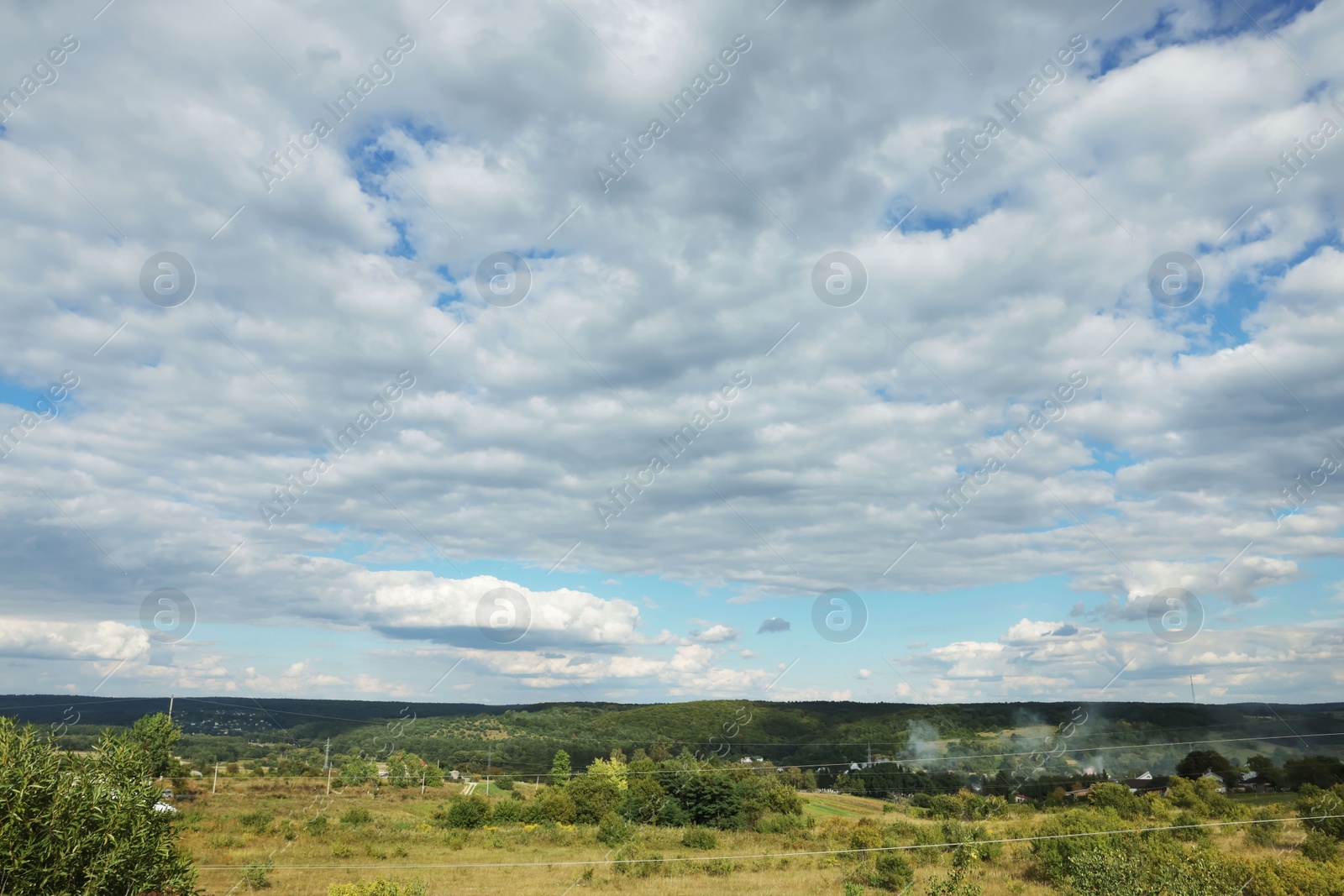 Photo of Picturesque view on beautiful cloudy sky and green field