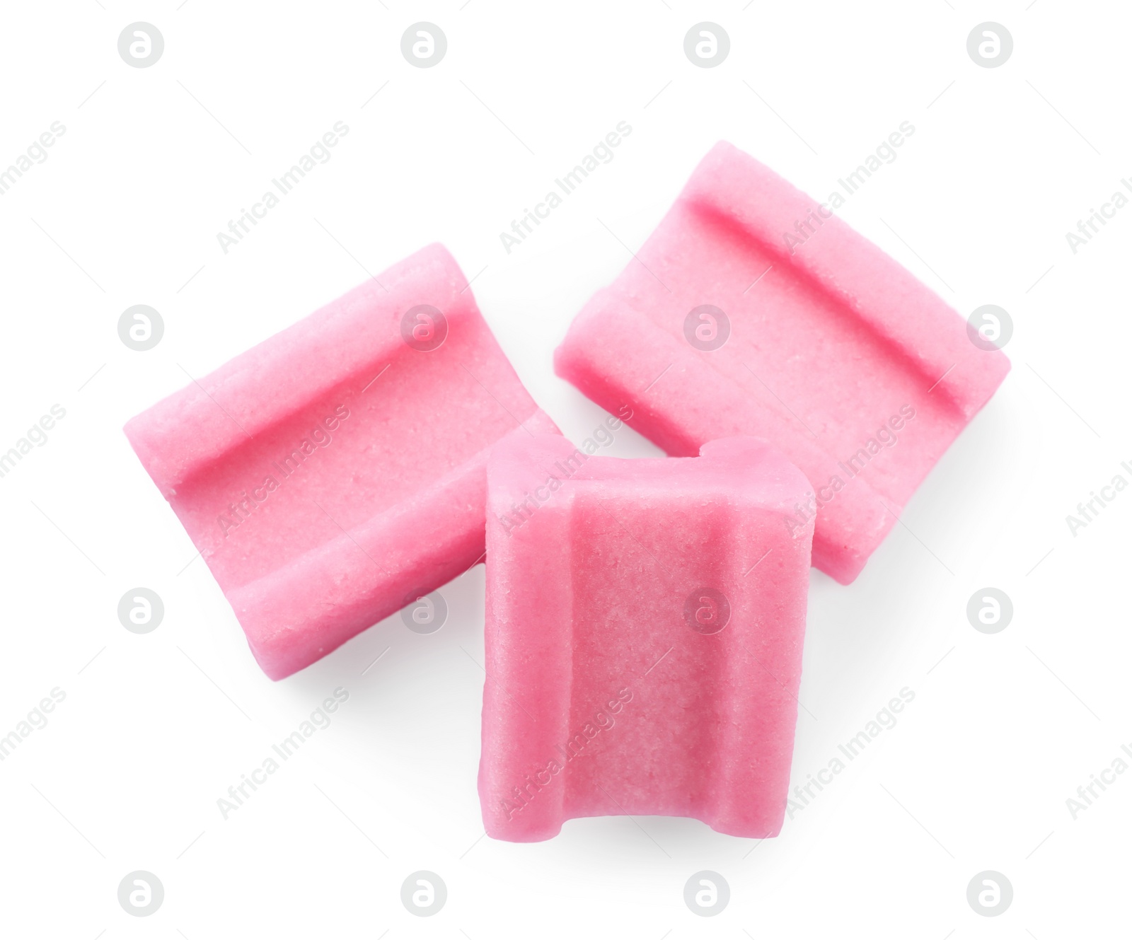 Photo of Tasty pink chewing gums on white background, top view