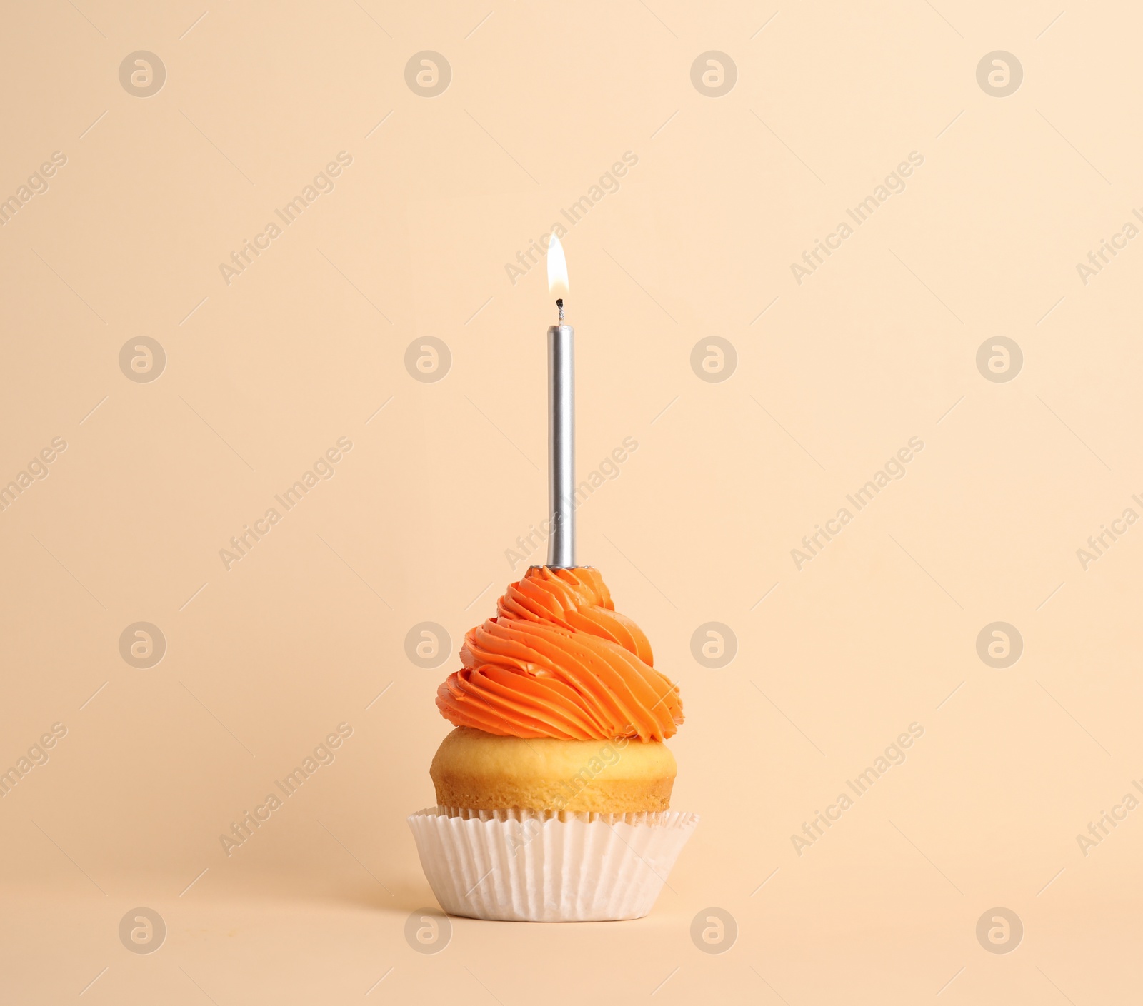Photo of Birthday cupcake with candle on beige background