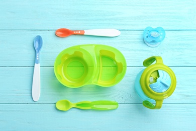 Photo of Flat lay composition with baby tableware for food on wooden background