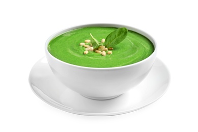 Bowl of healthy green soup with fresh spinach on white background