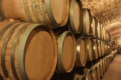 Photo of Large wooden barrels in wine cellar, closeup