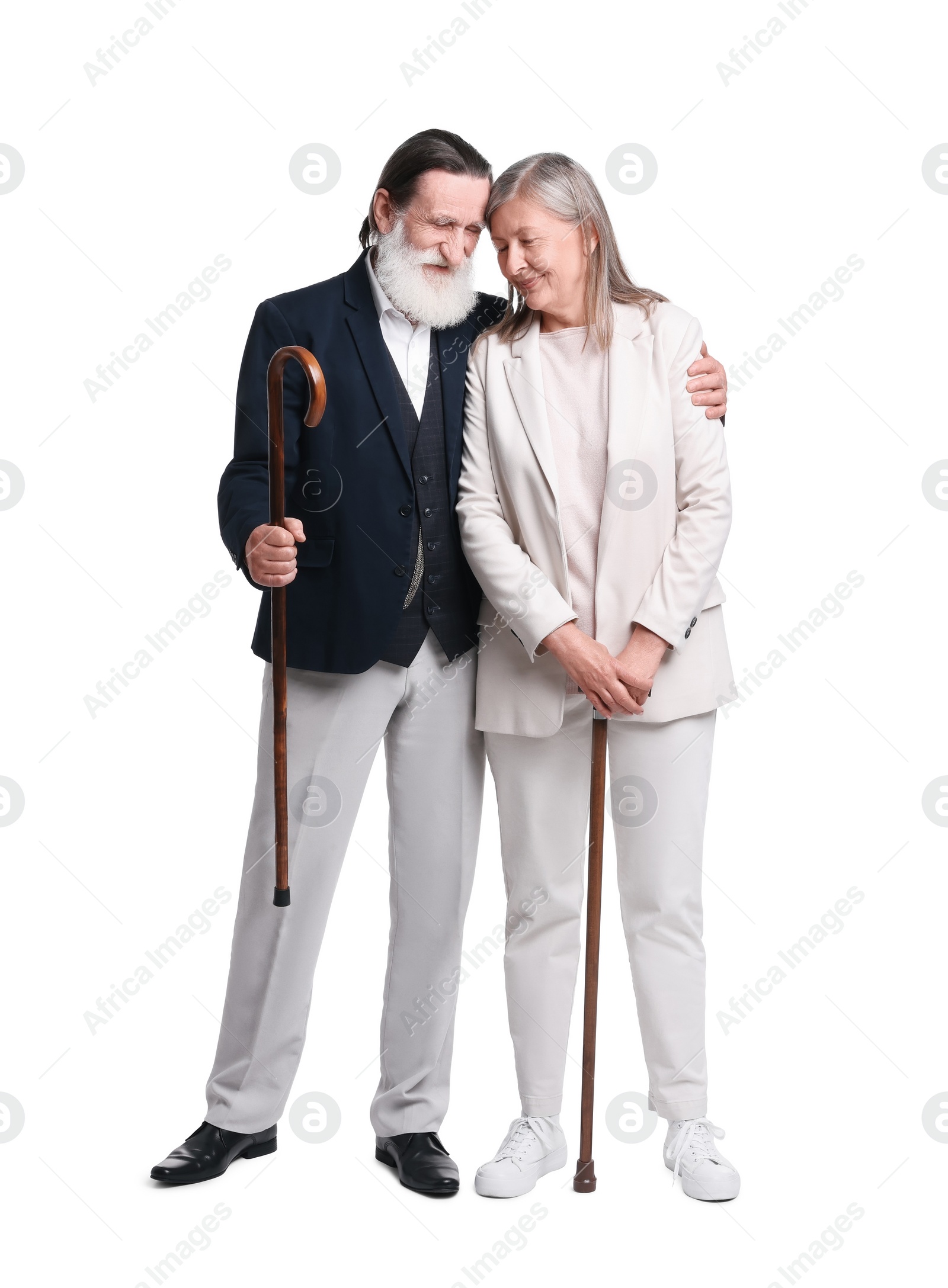 Photo of Senior man and woman with walking canes on white background