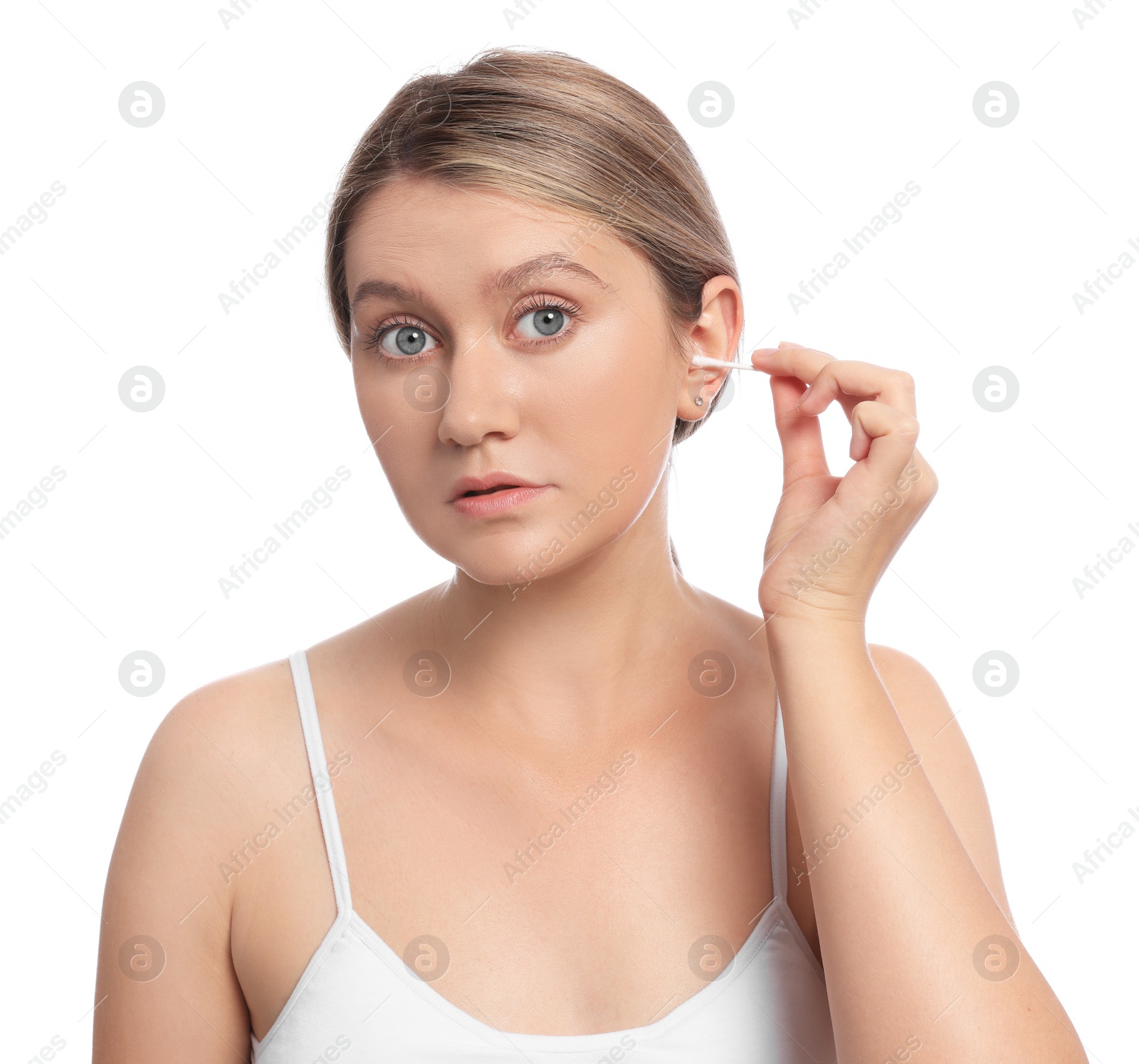 Photo of Young woman cleaning ear with cotton swab on white background