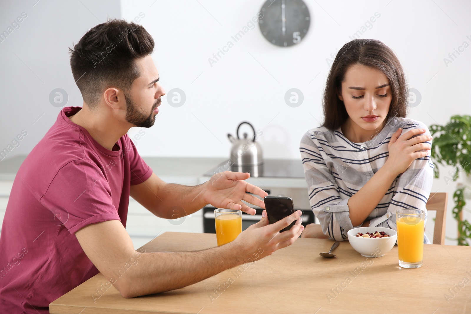 Photo of Young couple arguing at home. Problems in relationship