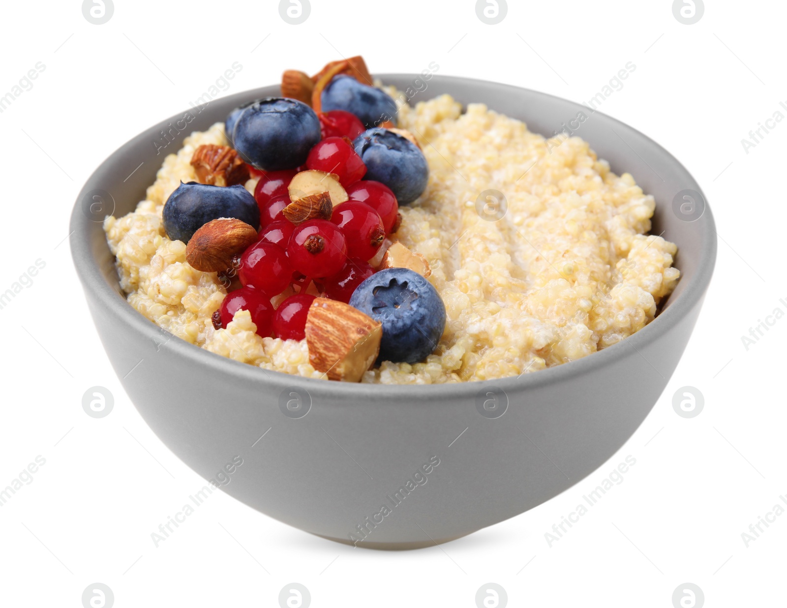 Photo of Bowl of delicious cooked quinoa with almonds, cranberries and blueberries isolated on white