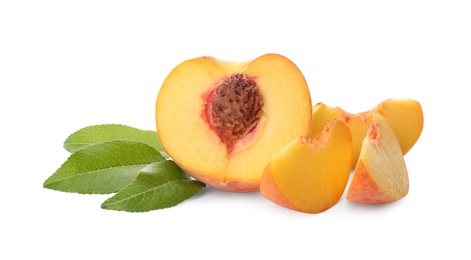 Photo of Cut fresh ripe peach with leaves on white background