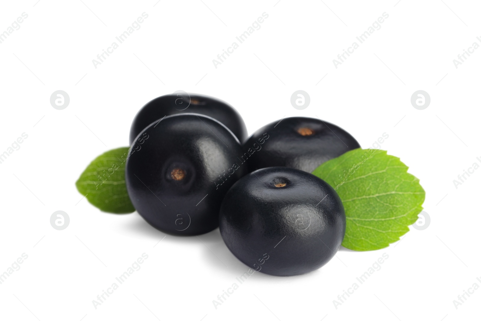 Photo of Pile of fresh ripe acai berries and green leaves on white background