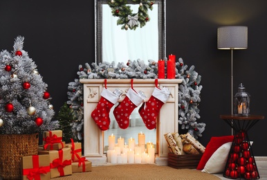Fireplace with Christmas stockings in festive room interior