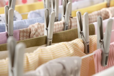 Photo of Clean laundry hanging on drying rack, closeup