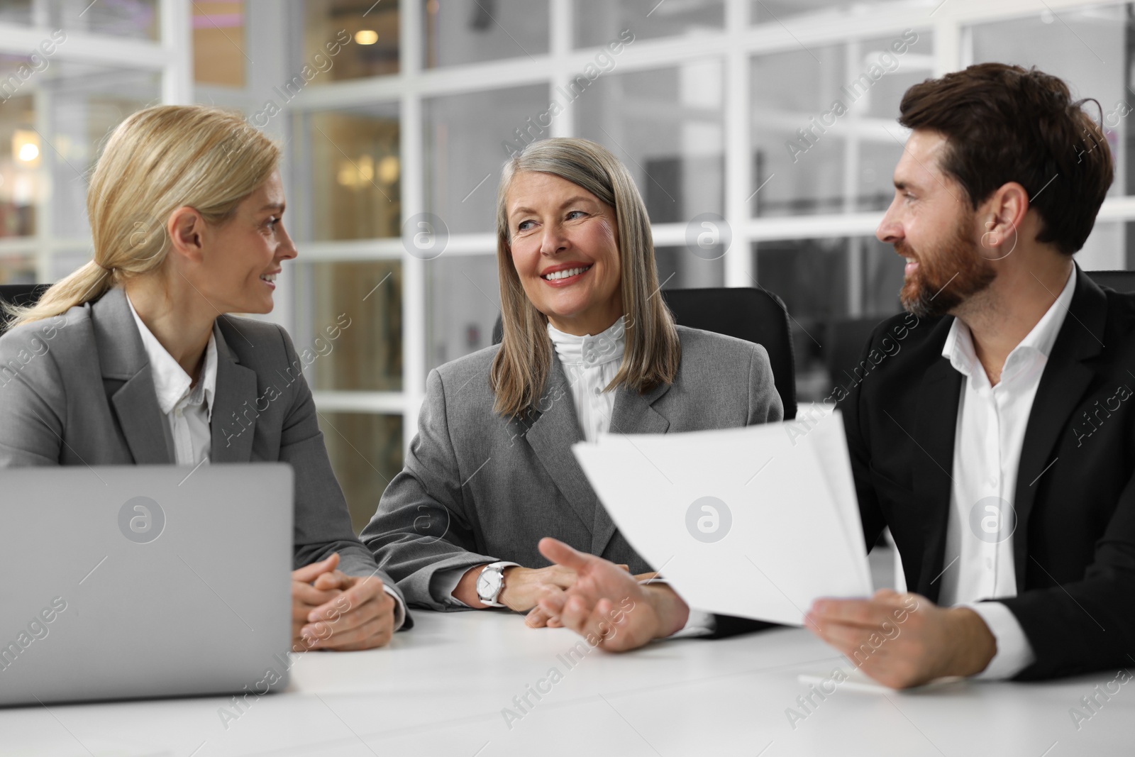 Photo of Lawyers working together at table in office