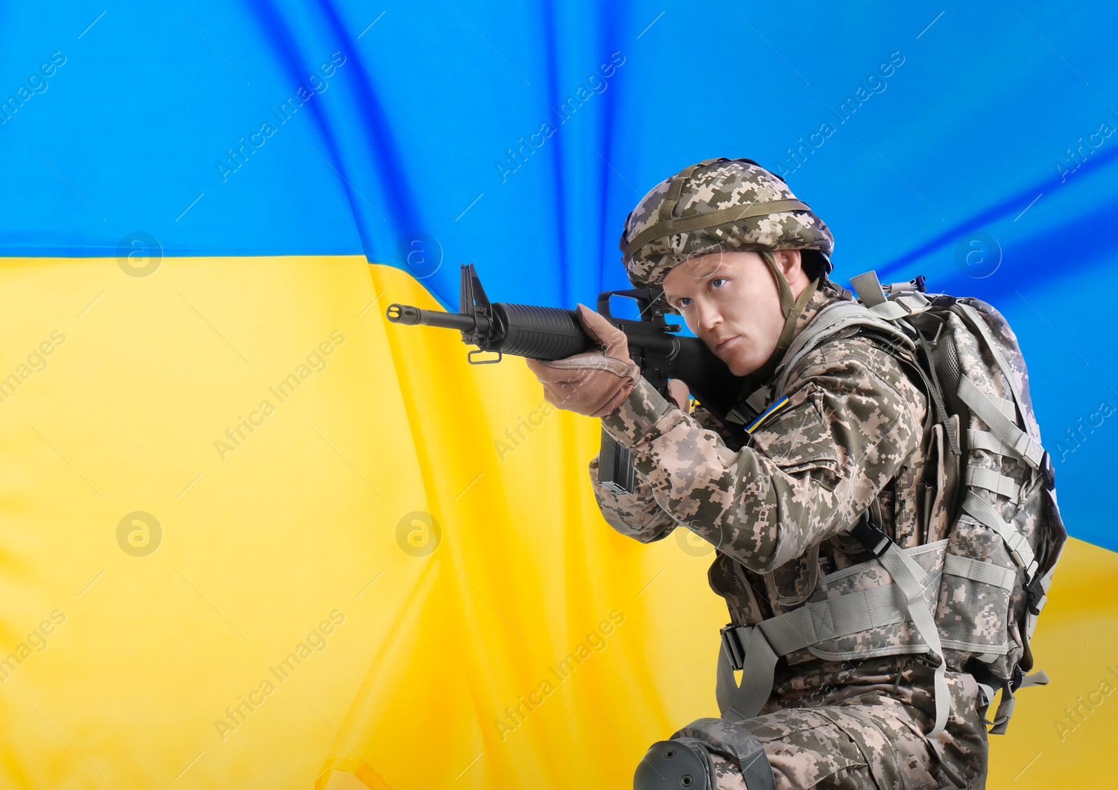 Image of Armed soldier in military camouflage uniform and Ukrainian flag on background, space for text. Stop war