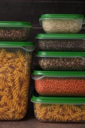 Plastic containers filled with food products on brown table