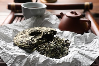 Broken disc shaped pu-erh tea on tray, closeup. Traditional ceremony