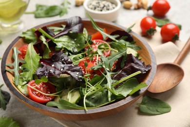 Photo of Tasty fresh vegetarian salad and ingredients on grey table, closeup