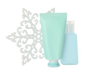 Set of cosmetic products with hand cream and snowflake isolated on white. Winter skin care