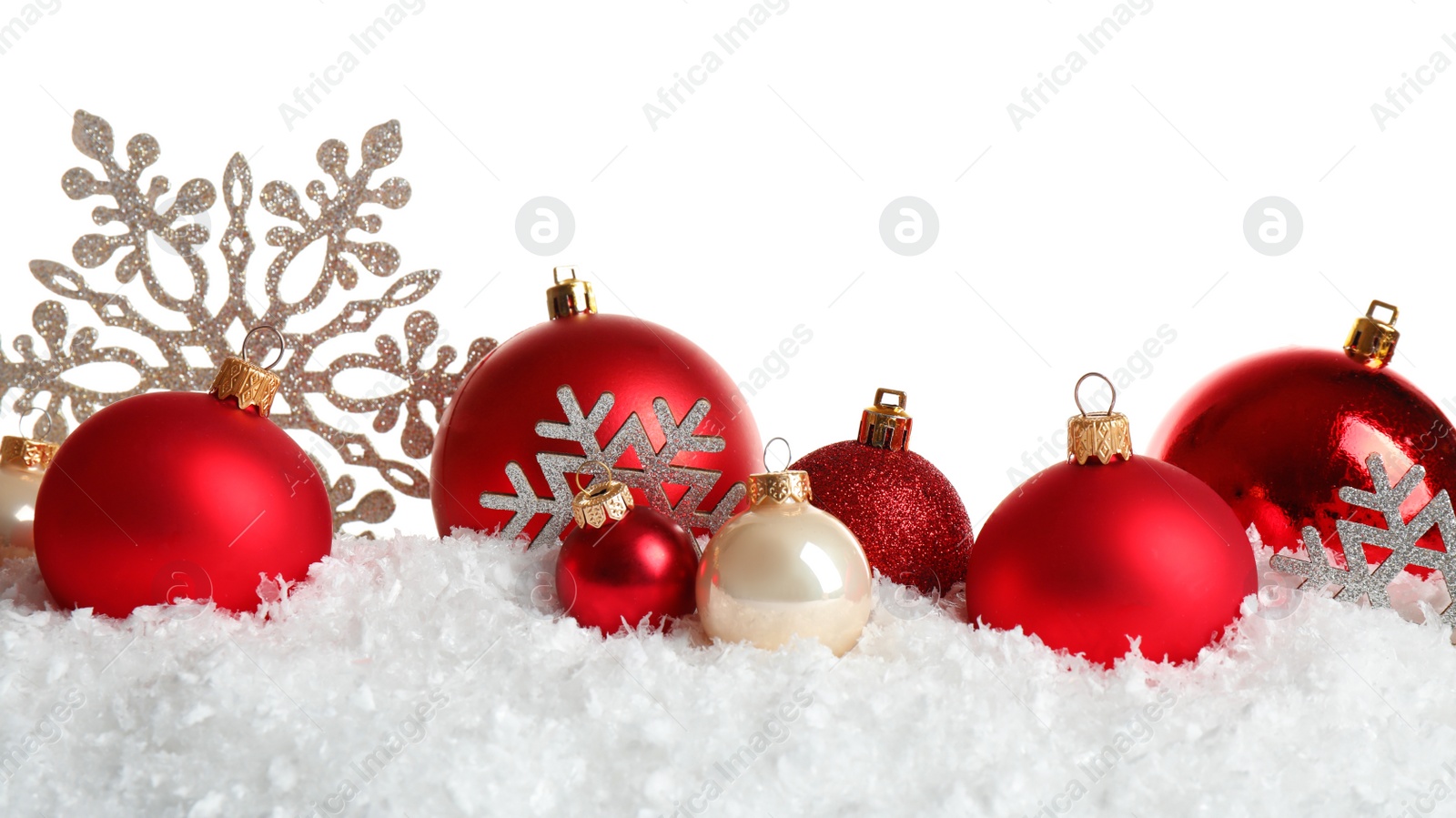 Photo of Christmas tree decoration on artificial snow against white background