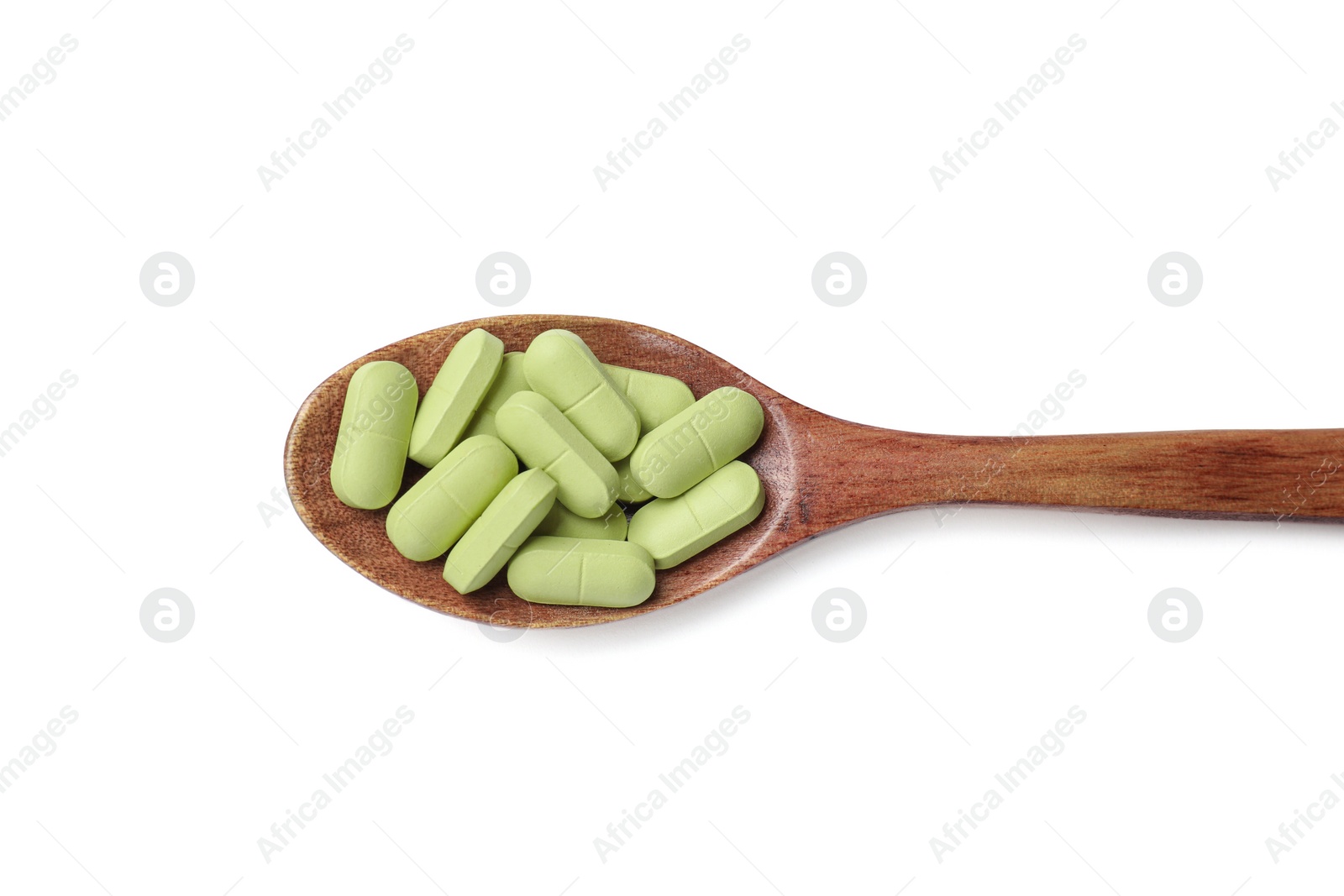 Photo of Vitamin capsules in wooden spoon isolated on white, top view