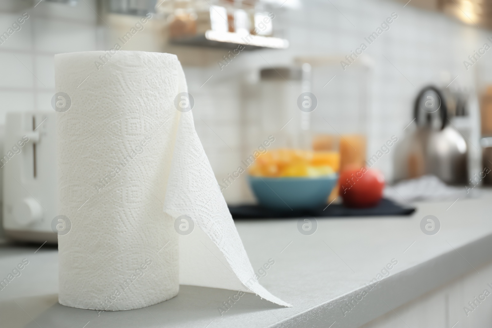 Photo of Roll of paper towels on table in kitchen, space for text