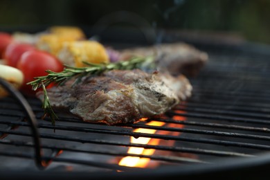 Photo of Cooking tasty meat on barbecue grill, closeup