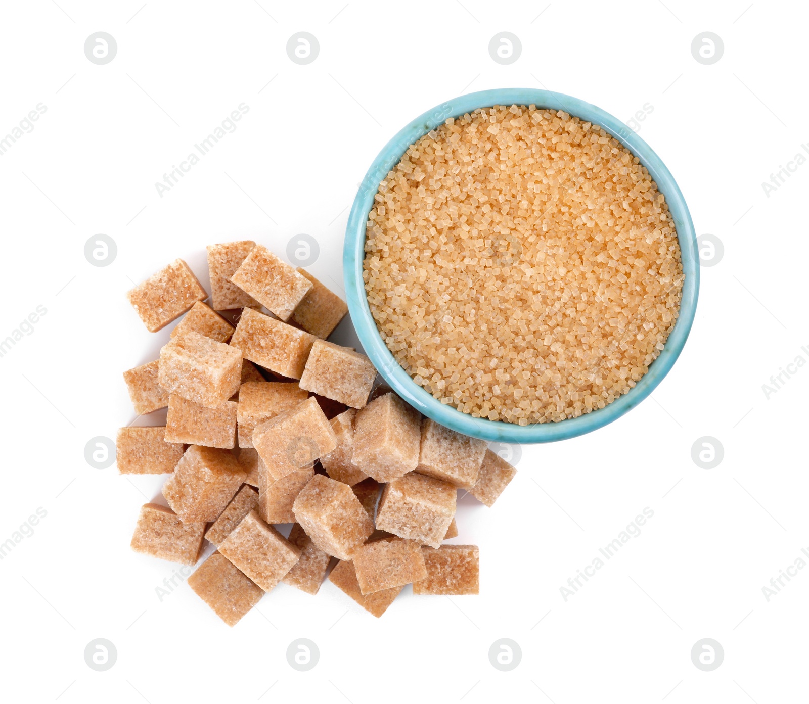 Photo of Different types of brown sugar and bowl isolated on white, top view