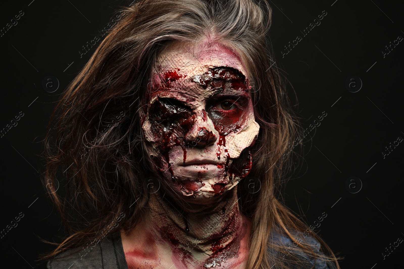 Photo of Scary zombie on dark background. Halloween monster