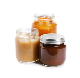 Jars with healthy baby food on white background