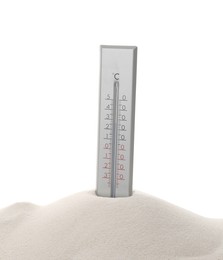 Weather thermometer in sand against white background