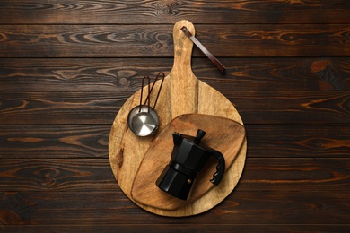Photo of Set of modern cooking utensils on brown wooden table, top view