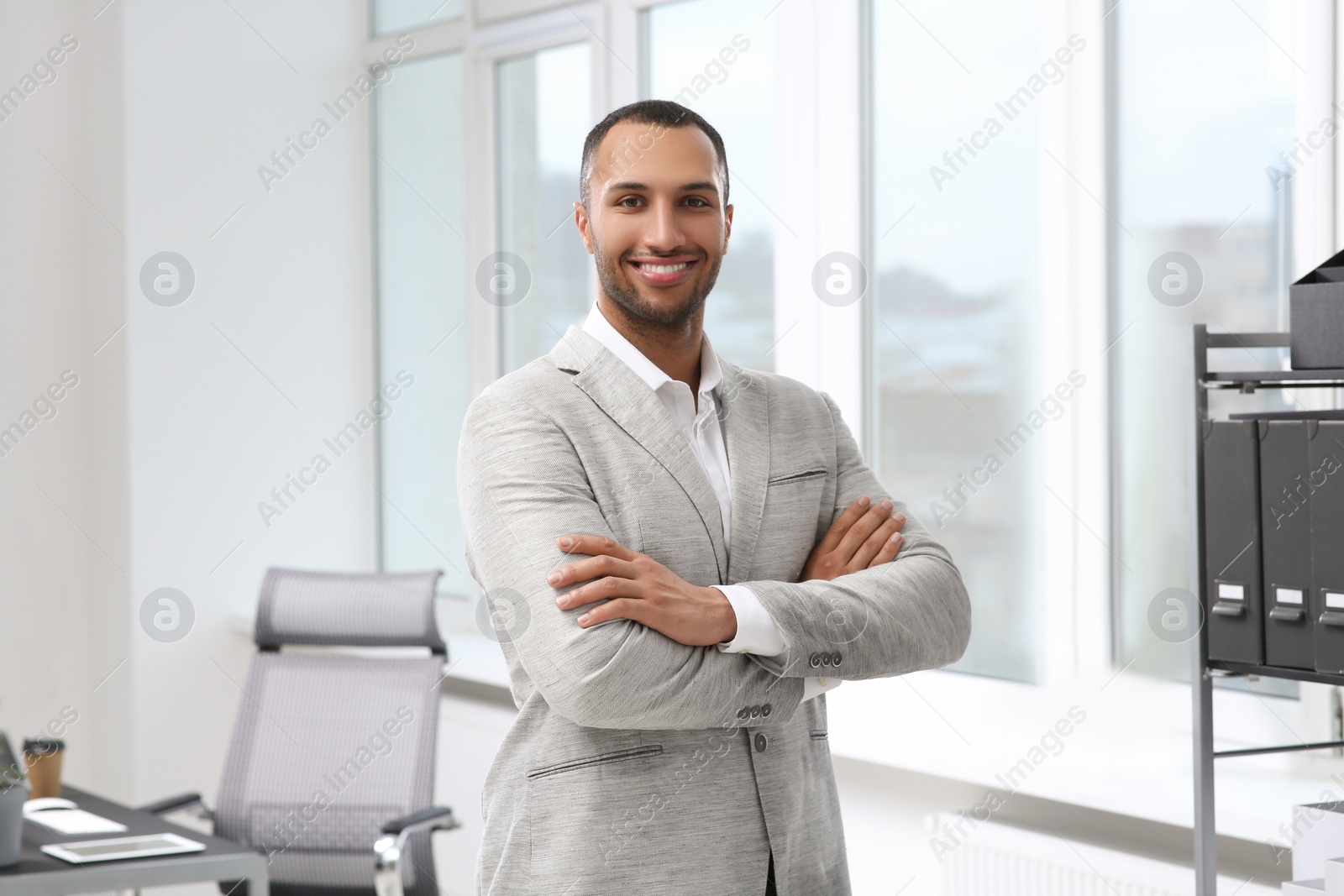 Photo of Smiling young businessman in his modern office