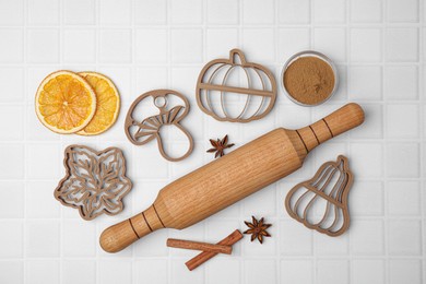 Photo of Flat lay composition with cookie cutters and rolling pin on white textured table