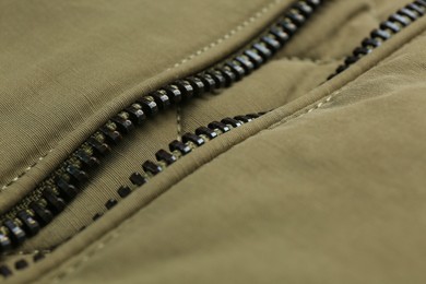 Photo of Grey jacket with zipper as background, closeup view