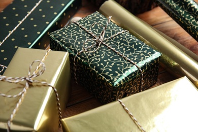 Photo of Beautifully wrapped gift boxes on wooden table