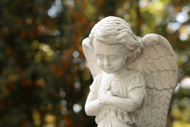 Photo of Beautiful statue of angel at cemetery, space for text