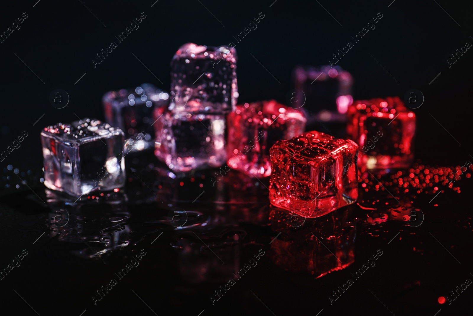 Photo of Pile of crystal clear ice cubes on black background