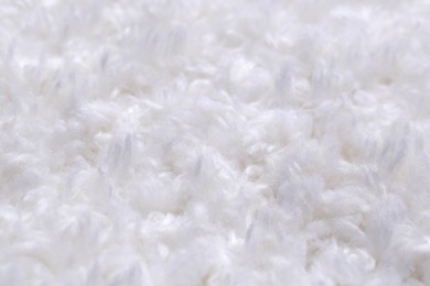 Photo of Soft white knitted fabric as background, closeup