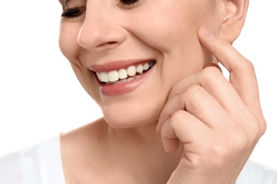 Young woman with beautiful smile on white background, closeup. Teeth whitening