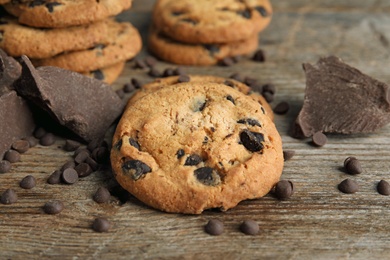 Photo of Delicious chocolate chip cookies on wooden table