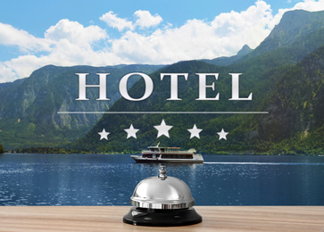 Image of 5 Star hotel. Reception desk with service bell and picturesque landscape on background