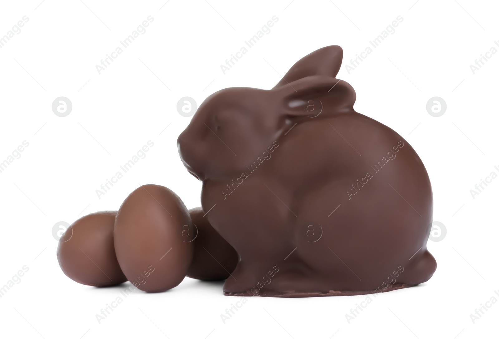 Photo of Chocolate Easter bunny and eggs on white background