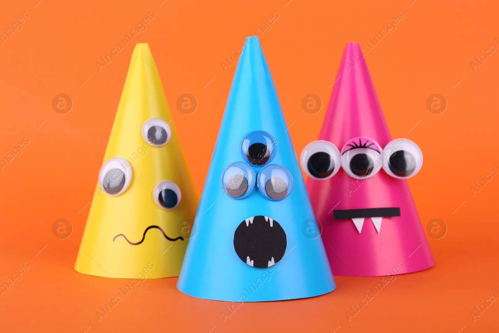 Photo of Spooky paper Halloween monsters on orange background