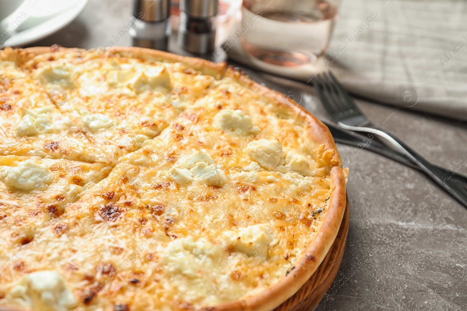 Photo of Delicious hot cheese pizza on grey table
