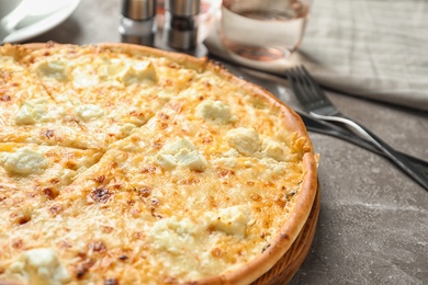 Delicious hot cheese pizza on grey table