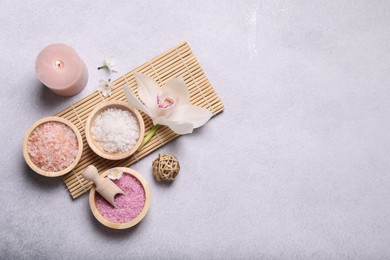 Photo of Flat lay composition with different spa products and orchid on light grey table. Space for text