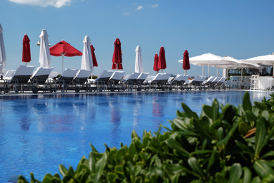 Photo of Outdoor swimming pool at sea resort on sunny day