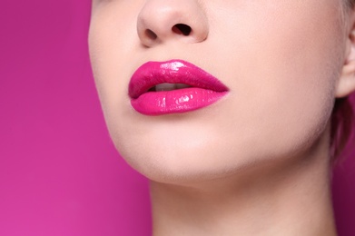 Photo of Beautiful young woman with perfect lips makeup on color background, closeup