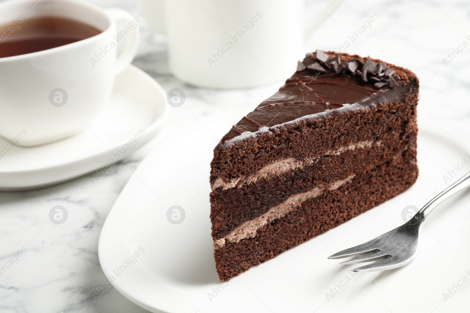 Photo of Piece of tasty chocolate cake served on plate