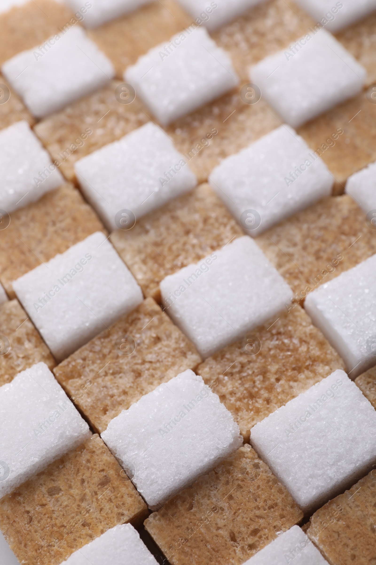 Photo of White and brown sugar cubes as background, closeup